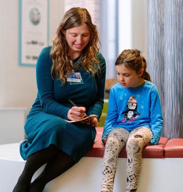 Mayo Clinic Caregiver with young patient.